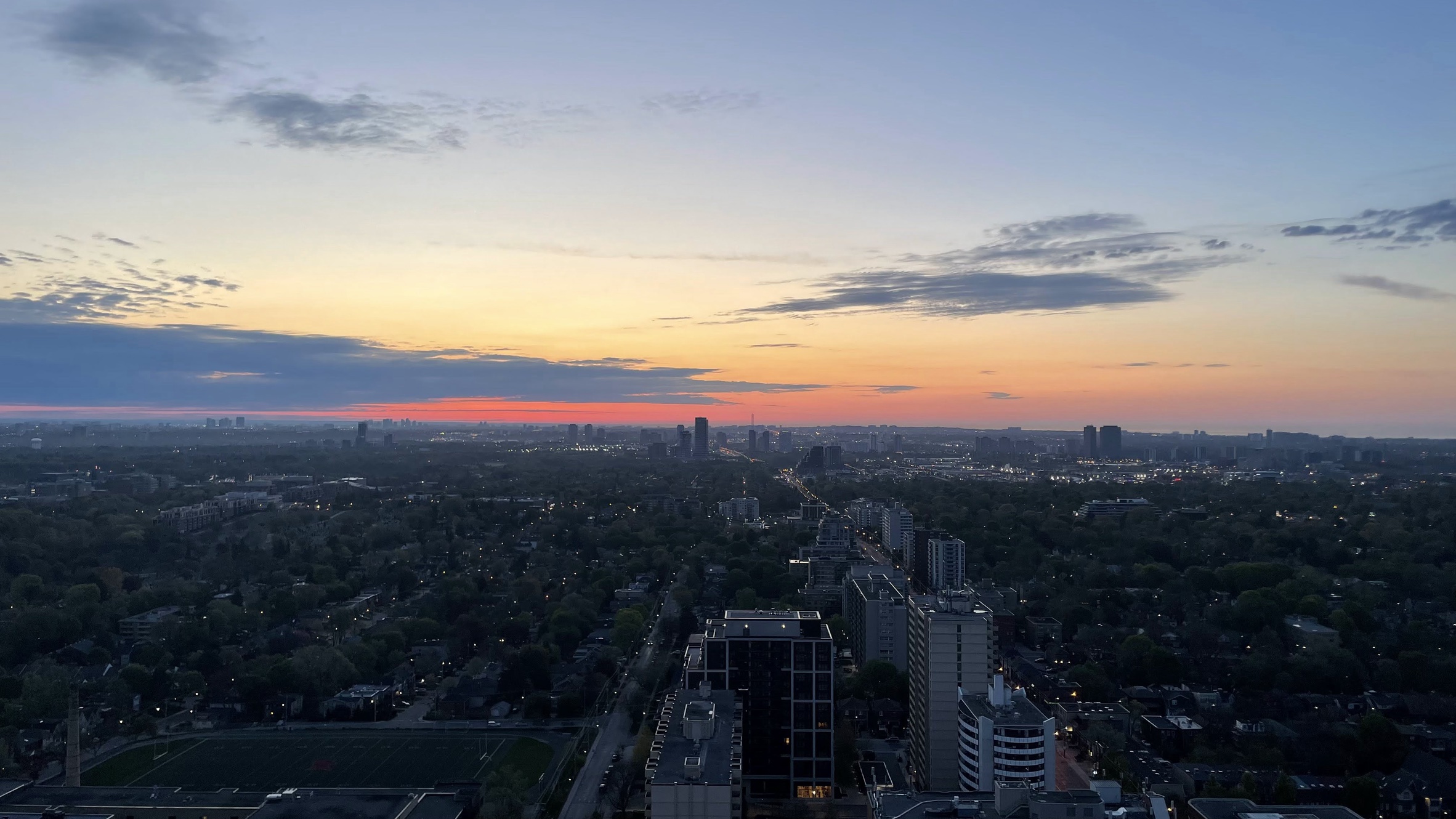 Toronto skyline at sunset, photographed from Will's apartment balcony in May 2023